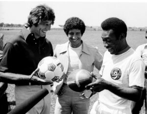 American football star Joe Namath exchanges balls with Pelé during a promotional event in New York in 1975